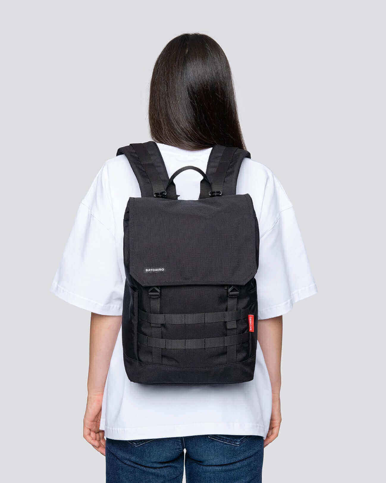 Stylish black Minato Lite backpack shown on a model, perfect for everyday use and weekend adventures.