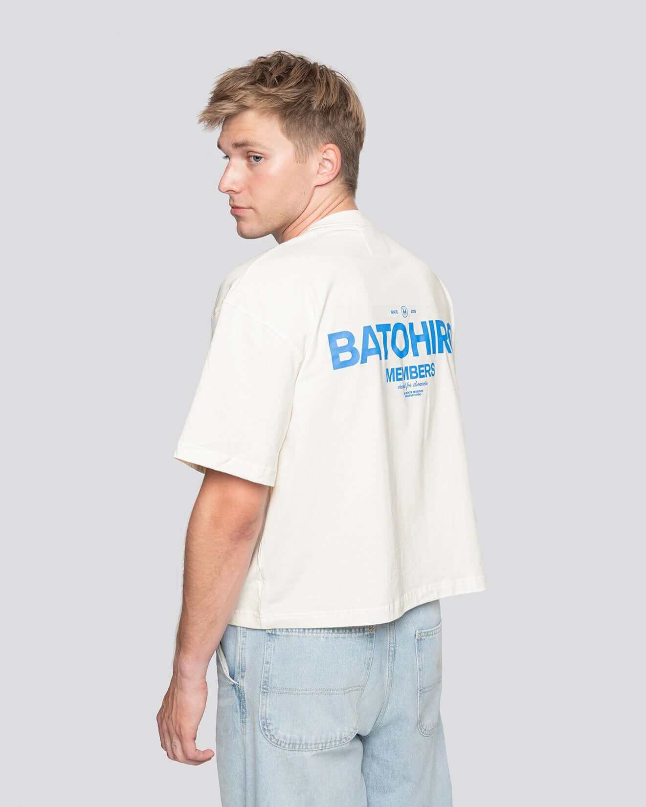 Man wearing a cropped oversized t-shirt with Batohiro design, showcasing a stylish back view.