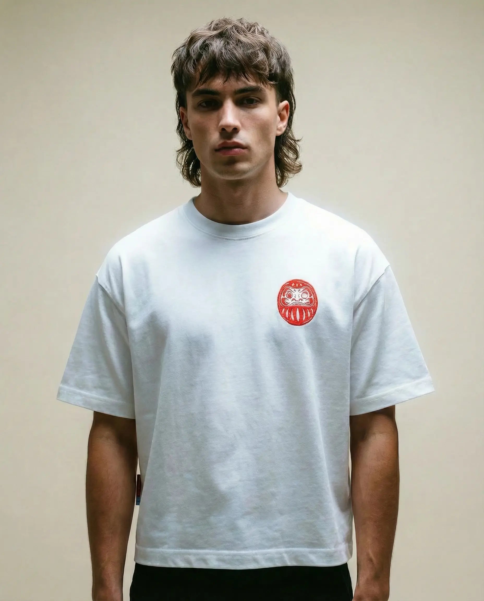 Daruma - White Cropped Oversized Tee worn by a model, featuring a red embroidery on the chest.
