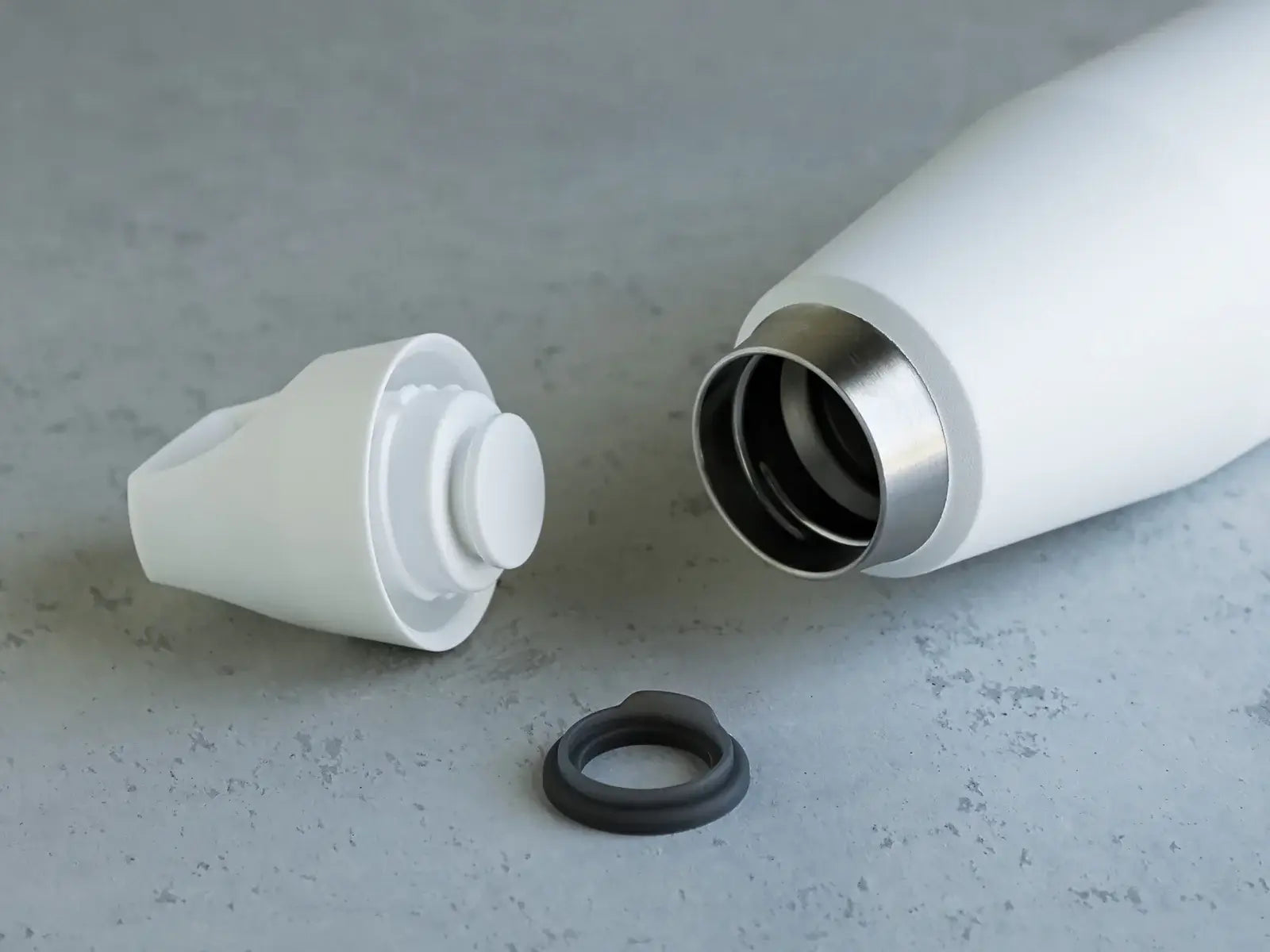 Close-up of the Trail Tumbler cap and inner structure, showcasing its sleek design and insulation features.