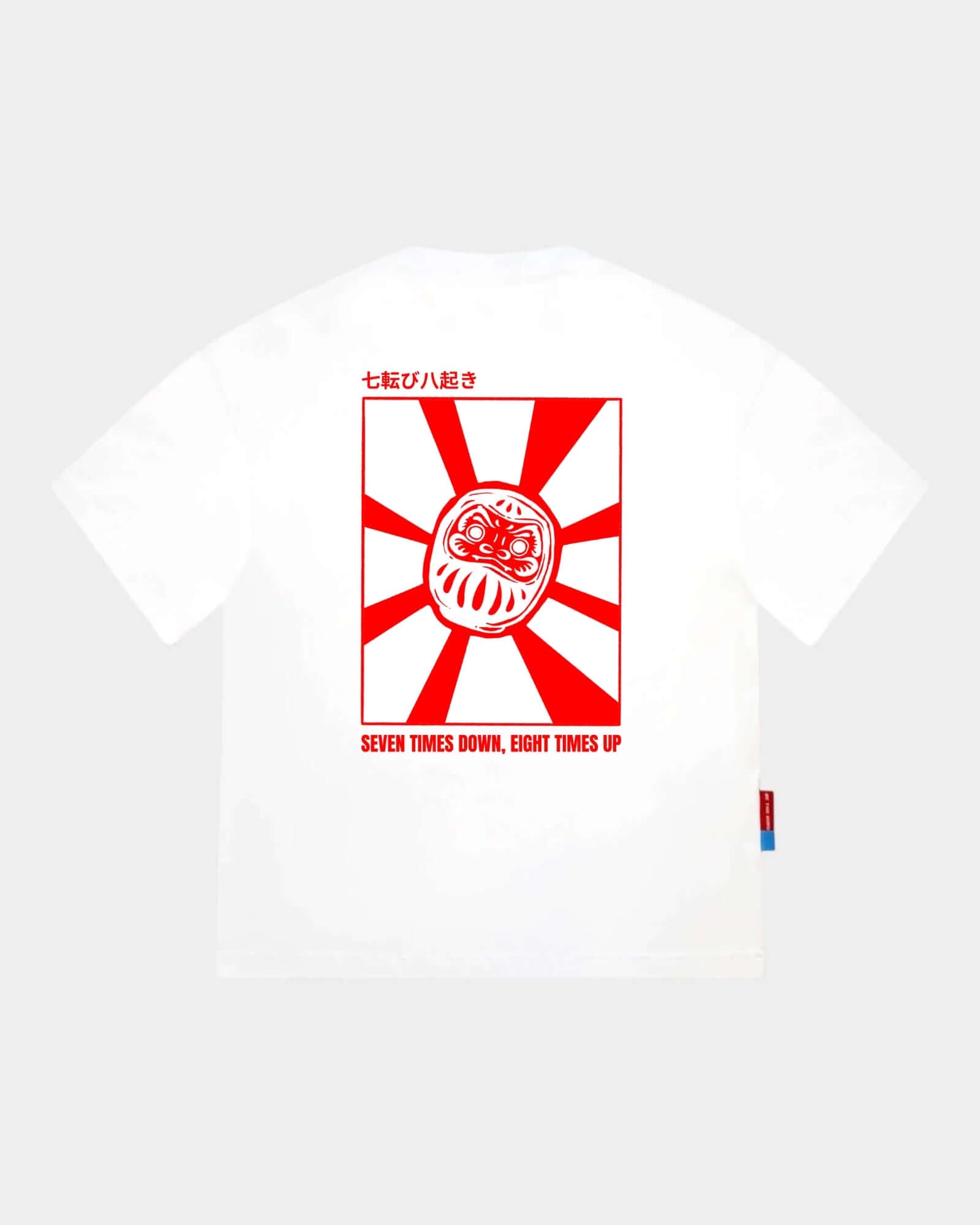 Daruma - White Cropped Oversized Tee with red back graphic and quote 'SEVEN TIMES DOWN, EIGHT TIMES UP'.