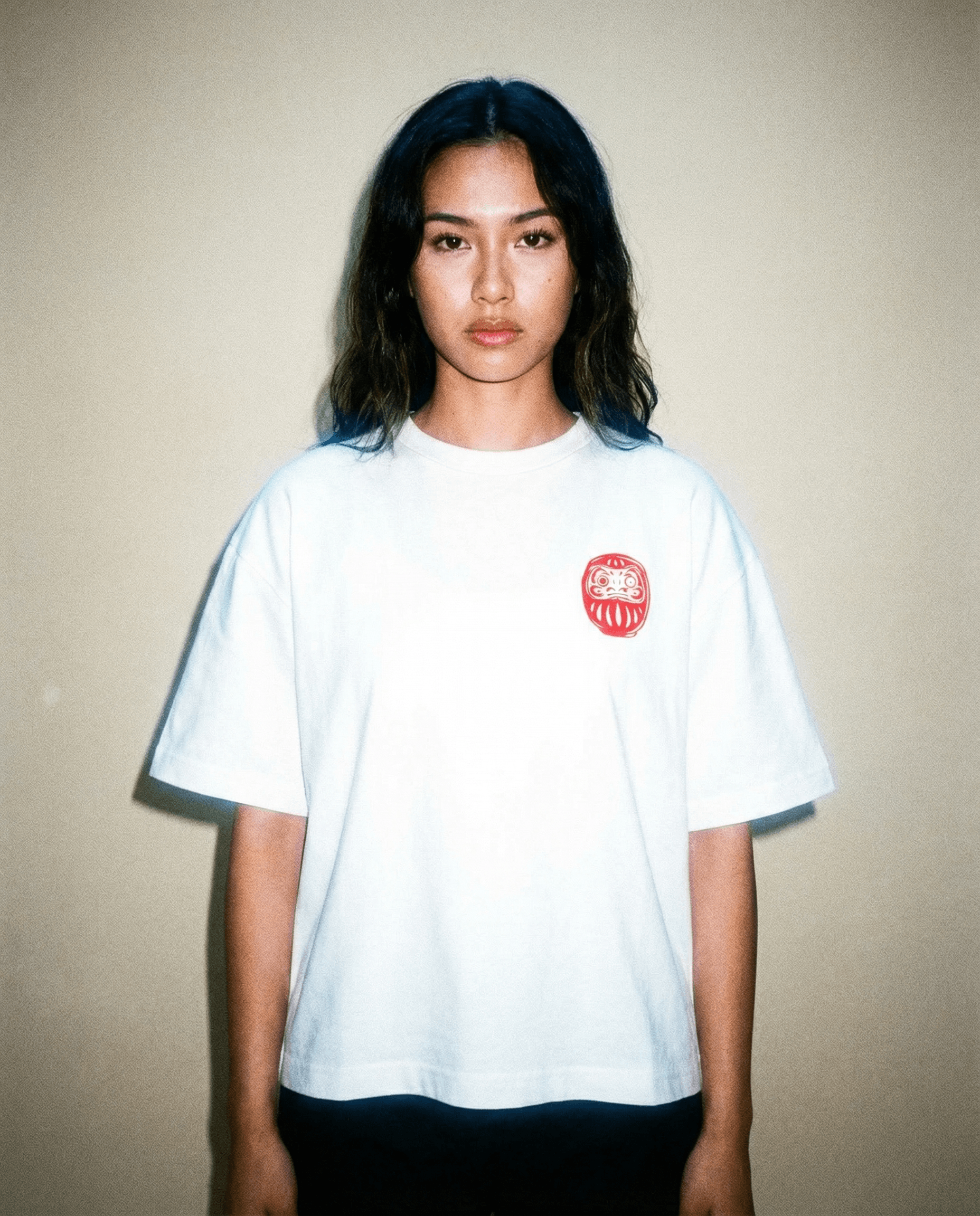 Daruma - White Cropped Oversized Tee worn by a model with a red embroidered design.