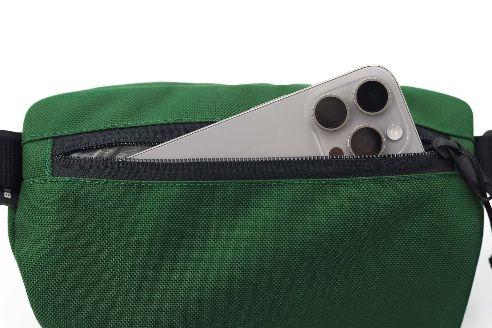 Sora 2.0 - Forest Green fanny pack with smartphone visible in pocket, showcasing modern design and premium materials.